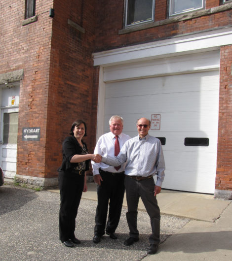 In a happier moment last summer, Town Manager Jennifer Tabakin congratulates Thomas Borshoff (right) on the conclusion of the sale of the Castle Street Firehouse. Between them is Borshoff's attorney, Ed McCormick. Photo: David Scribner