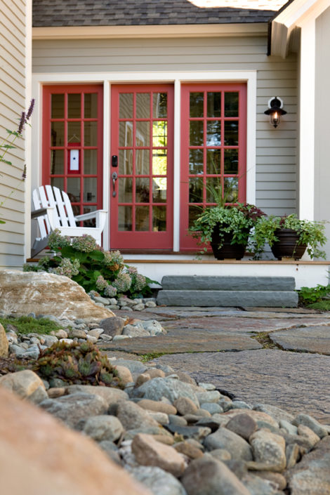 Mudroom entrance deck with undulating river stone beds along Goshen Stone walk, Hydrangea ‘Pinky Winky’ along deck corner. This is oriented to the north so it stays pretty shady. Photo: Michael Lavin Flower