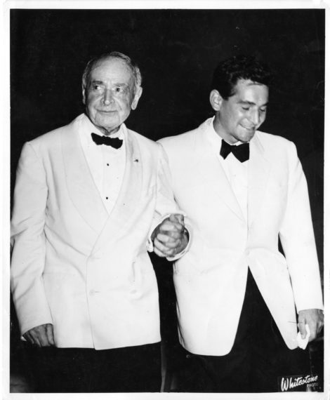 Serge Koussevitzky clasps hands with Leonard Bernstein during a curtain call in the Koussevitzky Music Shed at Tanglewood, ca 1947.