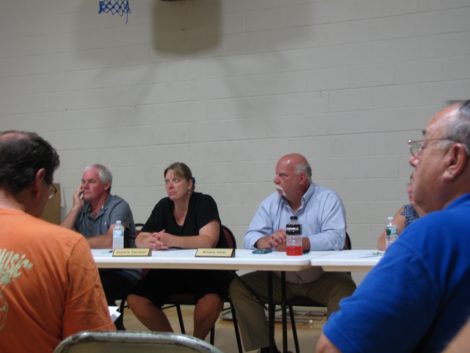 Selectmen (left to right) Donald Hawley, Roberta Sarnacki and William Hiller listening to Larry Gould explain the turbine project.
