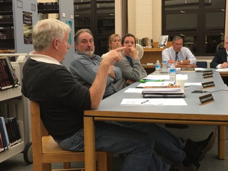Flynn gestures toward Dennis Sears during committee meeting. At the end of the table is Business Administrator Bruce Turner.