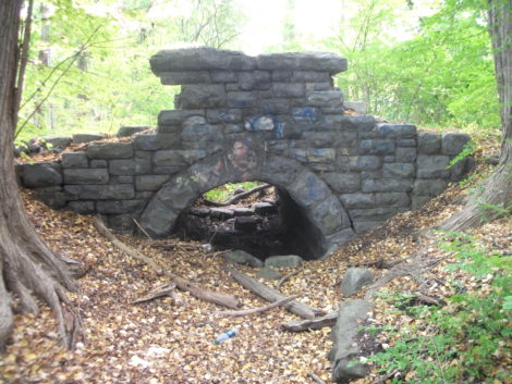 A nicely designed stone arch bridge stands behind Railroad Street Youth Project, on John Dewey Academy property. (Drew photo)