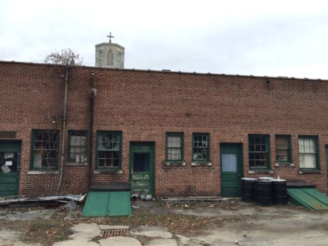 The back of Ried Cleaners, with the steeple of St. Peter's Chuch peeking above its roofline.