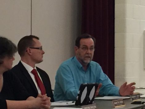 Fred Clark, at right, was the only School Committee member to vote against the restoration of funding. Committee member Jason St Peter listens as Clark explains his view.