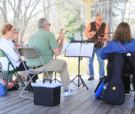 Paul Edelman, leading the Berkshire Ukulele Band's Sunday Strummers, in the gazebo behind Town Hall. Photo: David Edwards.