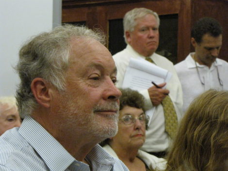 Nick Kelley, foreground, at Selectboard hearing. Standing behind him is his attorney, Edward McCormick.