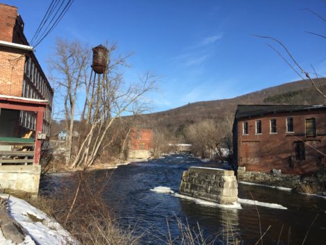 Mill buildings flank the river and the remains of a bridge abutment is a testament to a time when there was thriving commerce along the river. Photo: Heather Bellow
