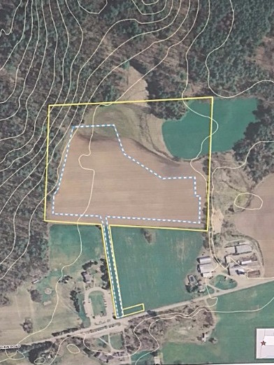 The solar array will fit inside the blue and white lines, a 10- to 12-acre parcel. The access road can be seen running alongside the playground and parking lot. It divides the Coons’ land, right, from the school soccer field, left.