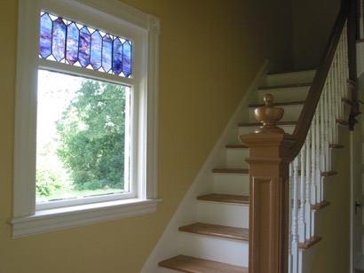 This accent came with the house. When selecting new colors for the entry and stairs, I chose a mellow brown for the newel post and gold for the walls with a soft white trim so that the stained glass would catch the eye.