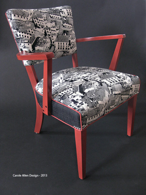 The black and white fabric print of Florence rooftops by Carole Allen Design is accented with piping, the color of which is picked up on the frame of this simple chair. Before upholstering the chair was painted with Liquitex professional spray, “Cadmium Red Light” Hue 2, then coated with a satin clear spray finish.