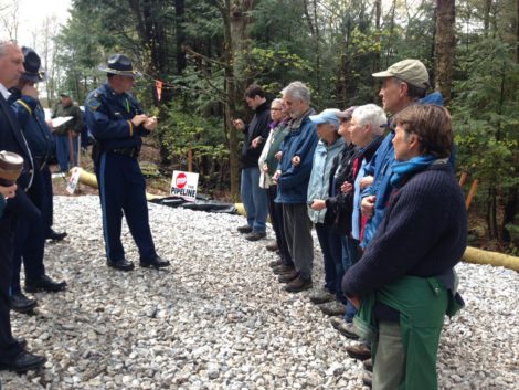 A State Trooper explains to protesters that they will be arrested if they deny access to Otis State Forest. Photo: Will Elwell
