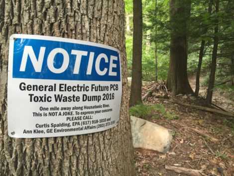 A sign tacked to a tree in the woods bordering Rising Pond in Housatonic, Mass., where GE would bury PCB sludge.