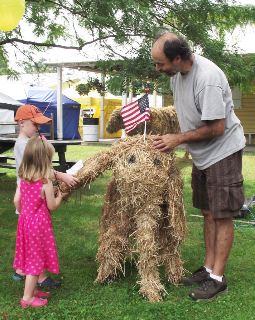 Mike DiMisa, right, shows young fairgoers how to build an elephant out of straw. Photo courtesy Columbia County Fair