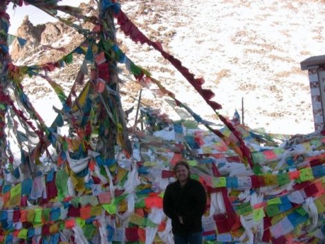 Wallman amidst Buddhist prayer flags.